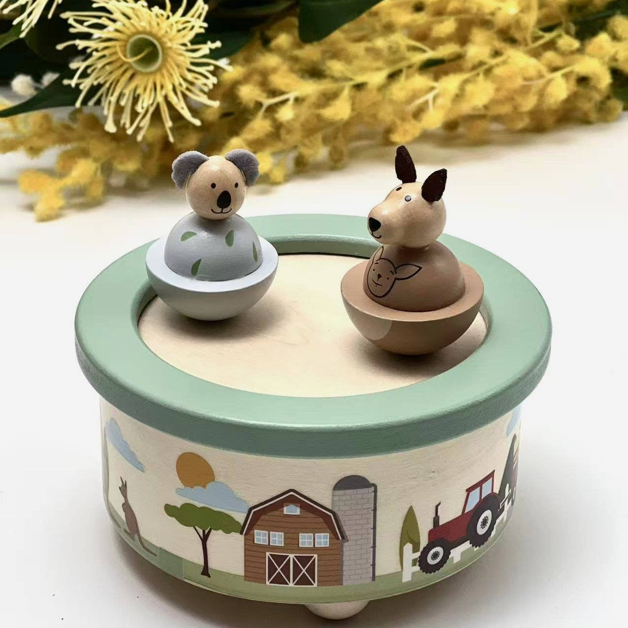 Wooden toy with animal figures on a decorative base with floral background