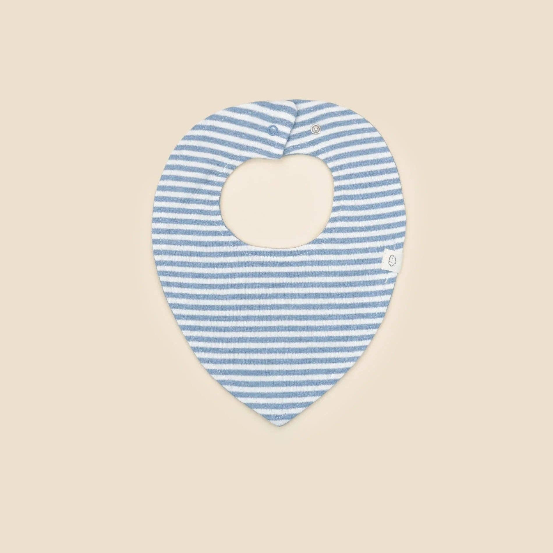 Blue and white striped baby bib on a beige background