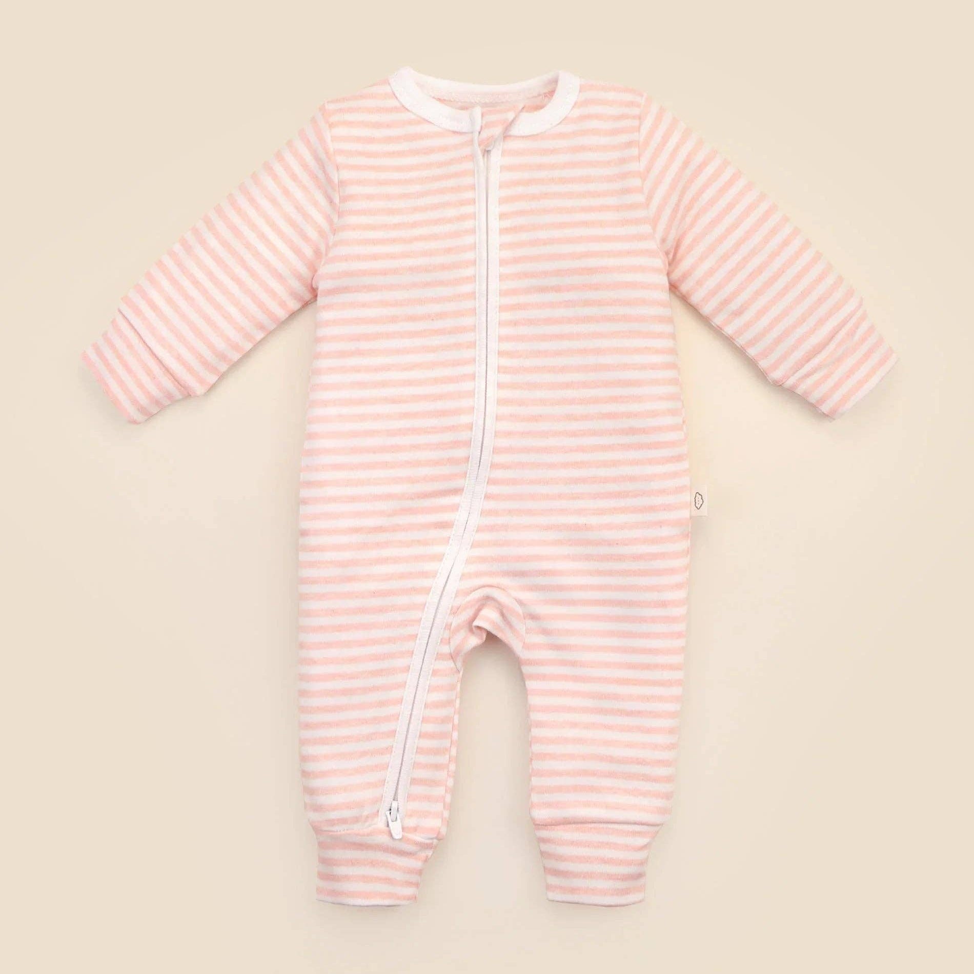 Pink striped baby onesie on a beige background