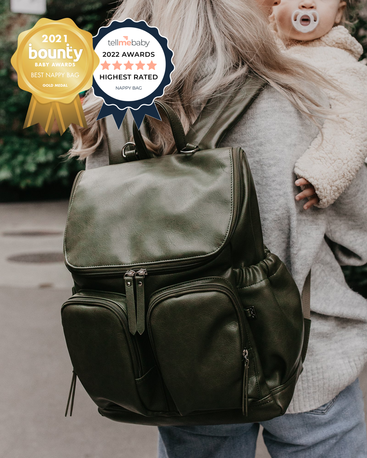 Person holding a green backpack with awards displayed above